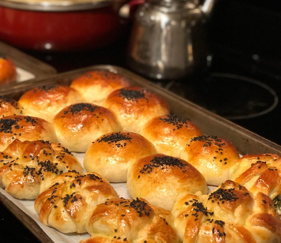 Freshly baked bread rolls cooling in a home kitchen