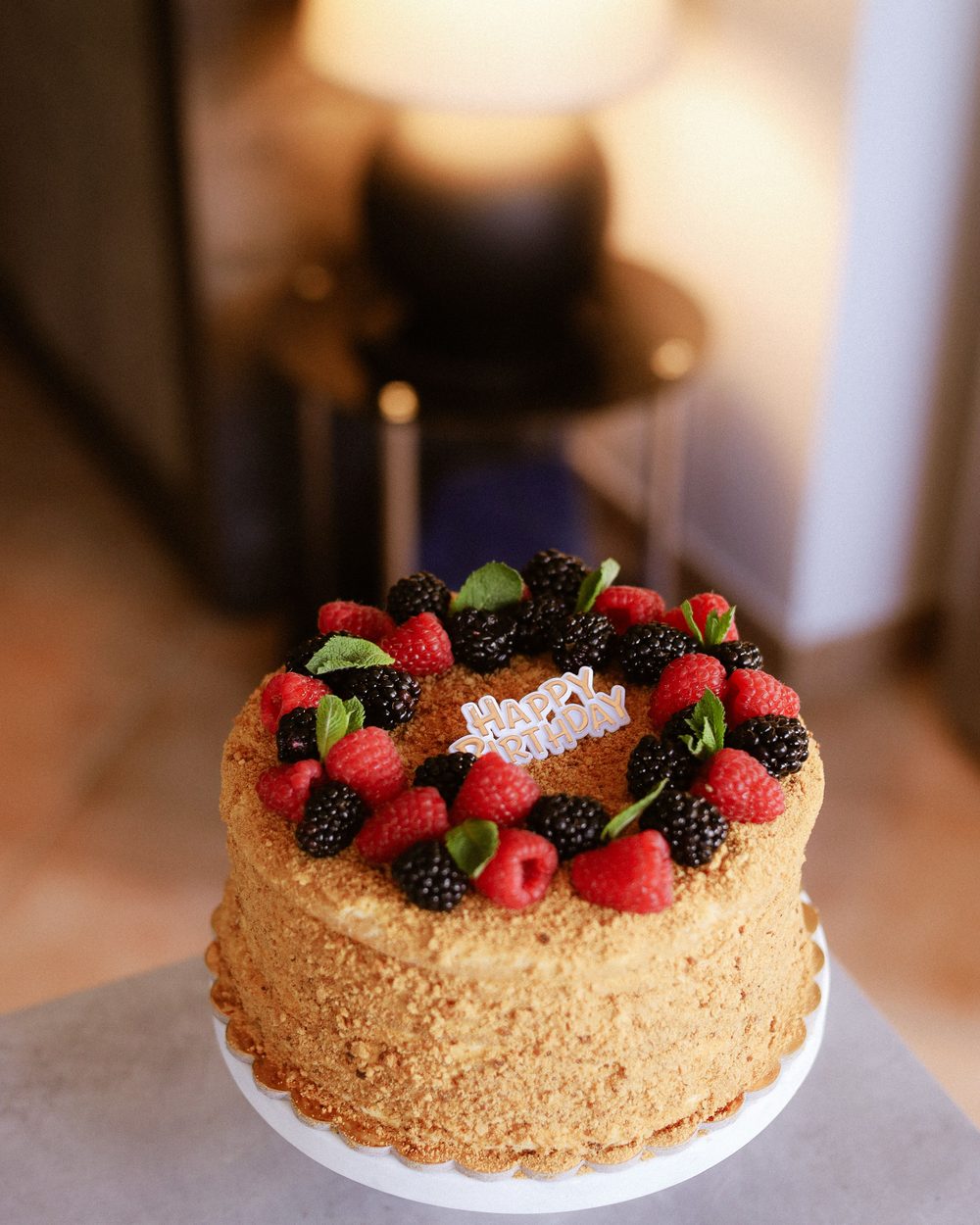 Celebration cake topped with fresh berries, made by a Scoffy baker